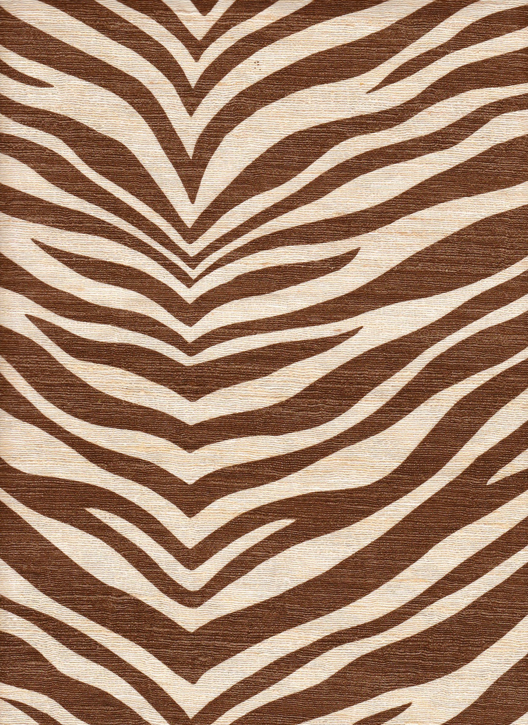 Detail of fabric in a zebra print in brown on a cream field.