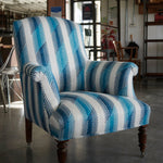 Armchair upholstered in a a playful broken stripe pattern in mottled navy on a cream field.