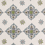 Detail of fabric in a diamond damask print in shades of green and blue on a cream field.