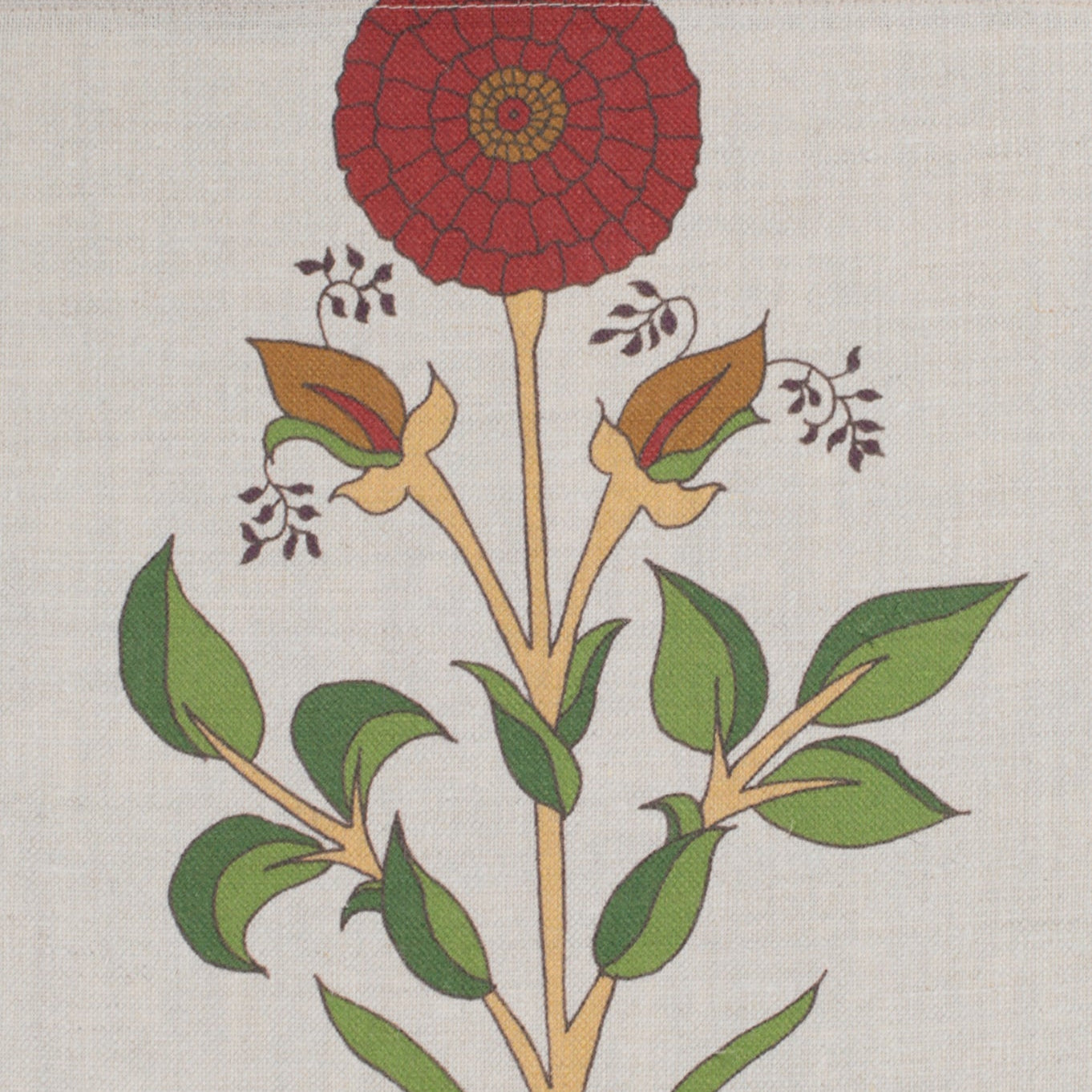 Detail of fabric in a large-scale marigold print in red, green and orange on a cream field.