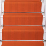 Striped flatweave runner in orange on white staircase