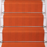 Striped flatweave runner in orange on white staircase