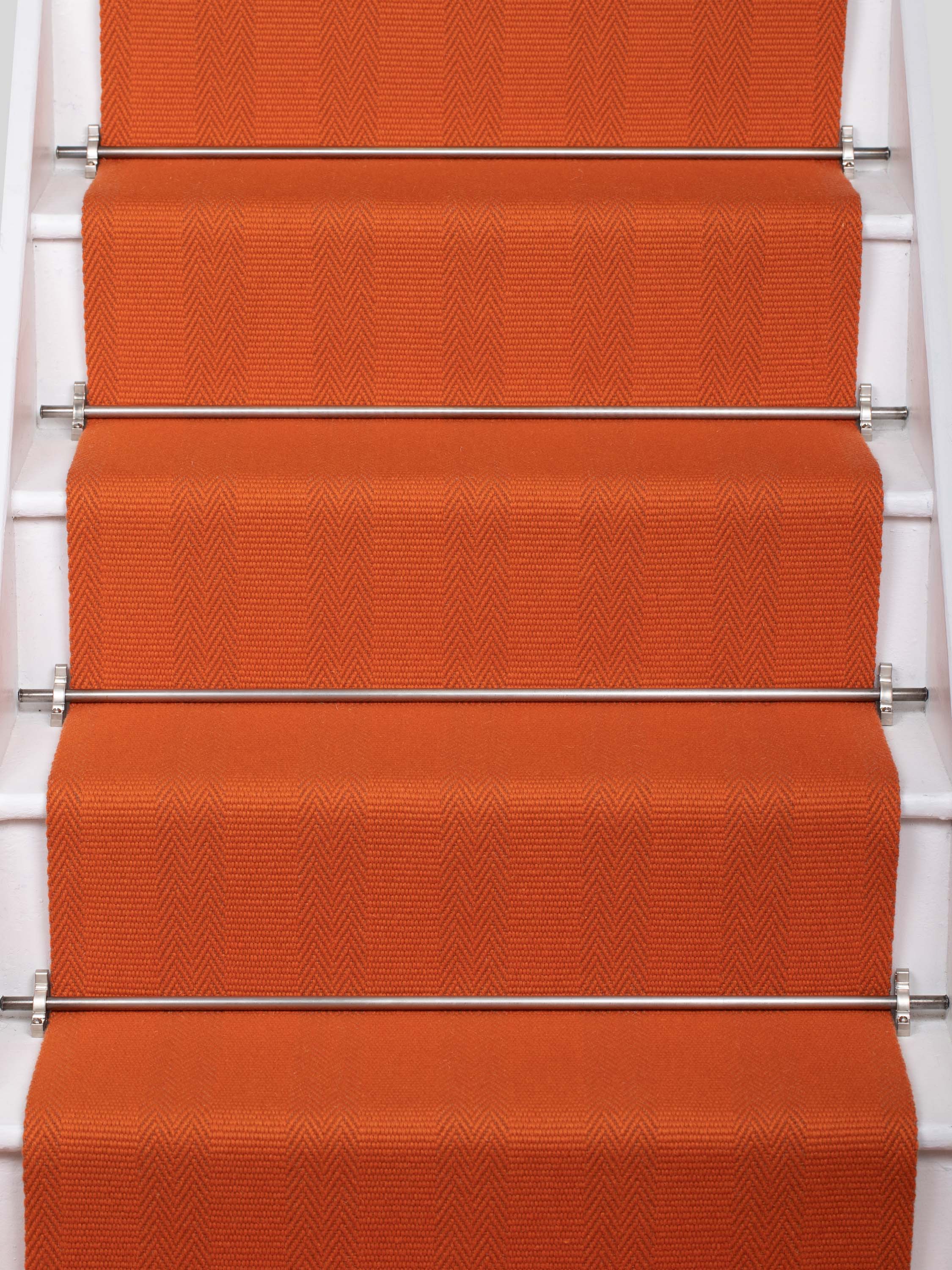 Striped flatweave runner in orange on white staircase