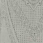 Detail of fabric in a dotted geometric print in gray on a light gray field.