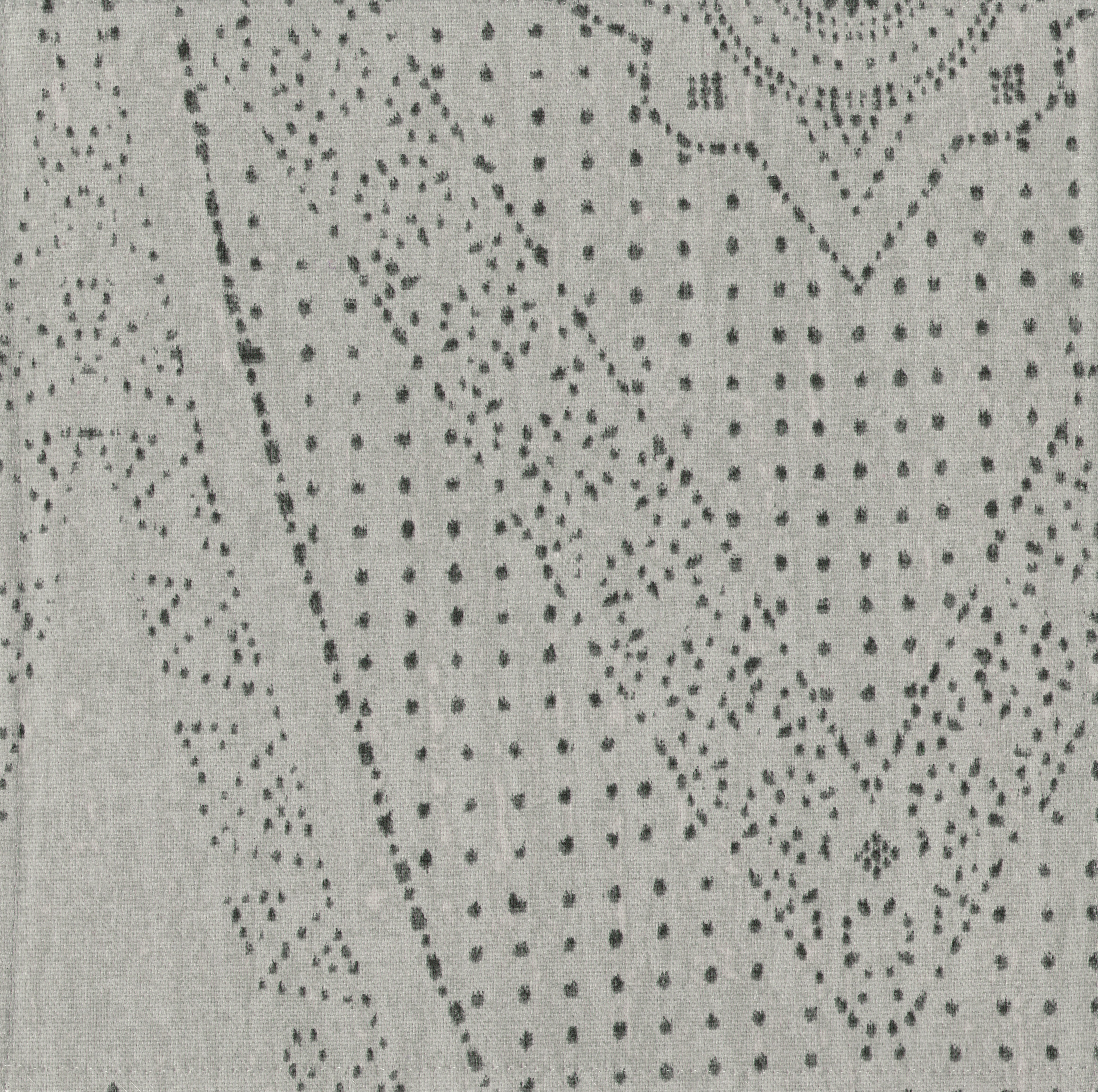 Detail of fabric in a dotted geometric print in gray on a light gray field.