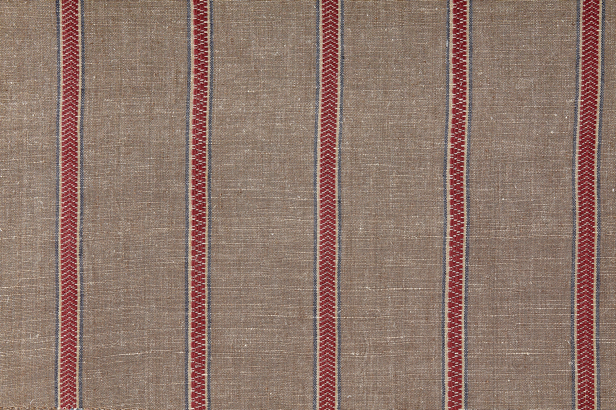 Detail of fabric in a chevron stripe print in brown and red with blue accents.