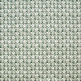 Detail of fabric in a floral grid print in white on a forest green field.