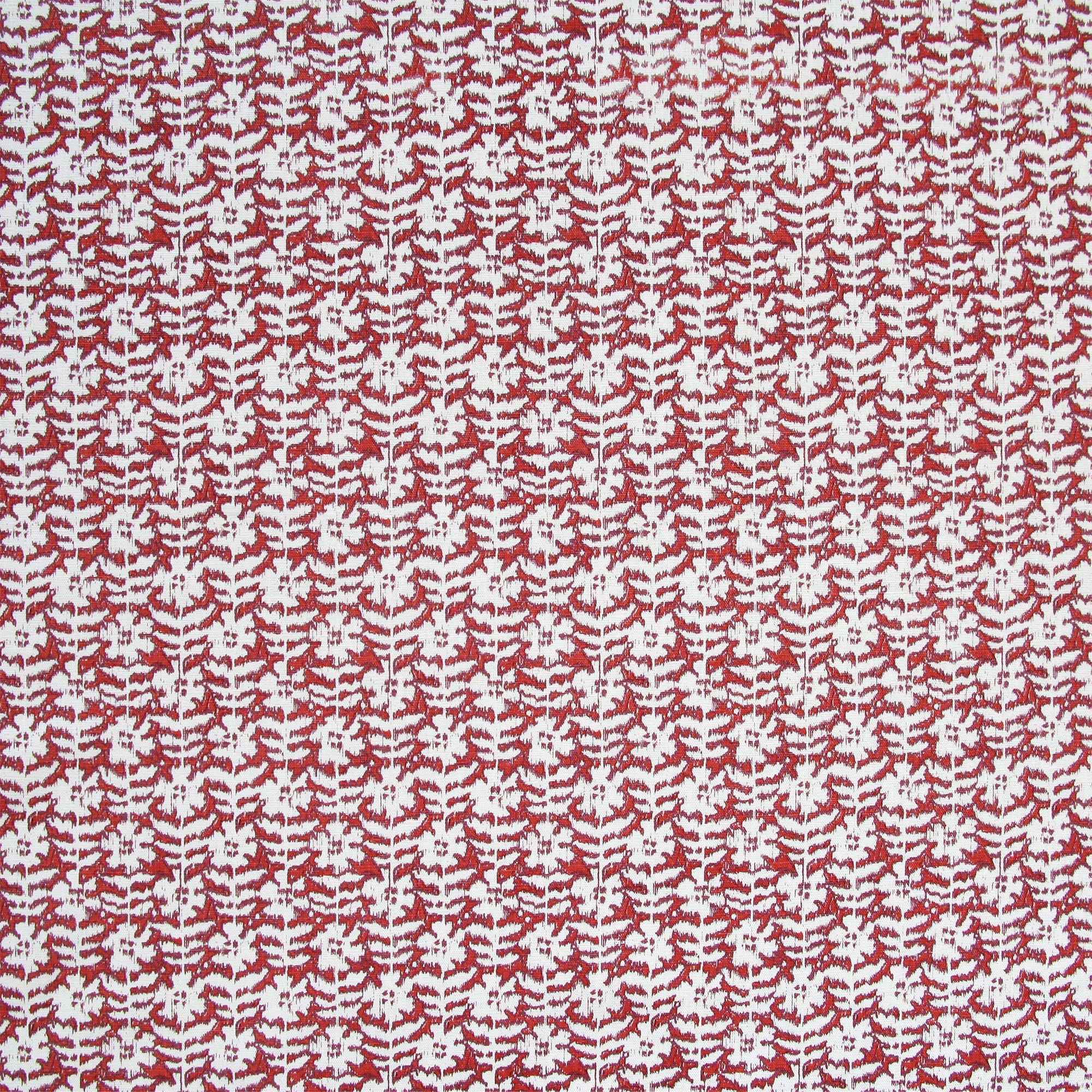 Detail of fabric in a floral grid print in white and maroon on a red field.