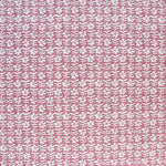 Detail of fabric in a floral grid print in white and red on a pink field.