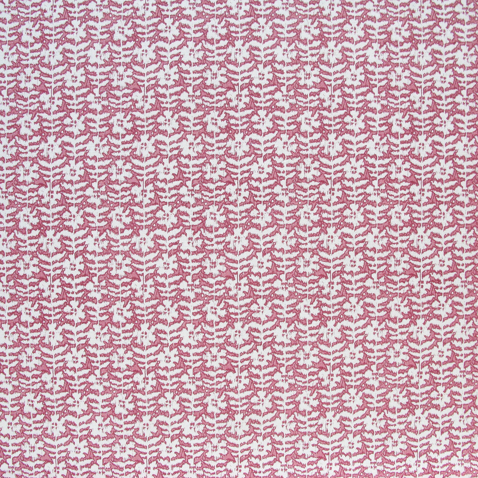Detail of fabric in a floral grid print in white and red on a pink field.