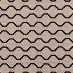 Patterned rug with black zigzag lines on a beige background
