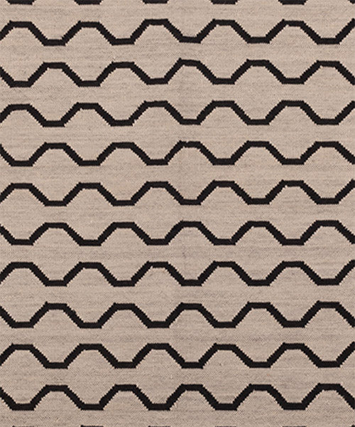 Patterned rug with black zigzag lines on a beige background