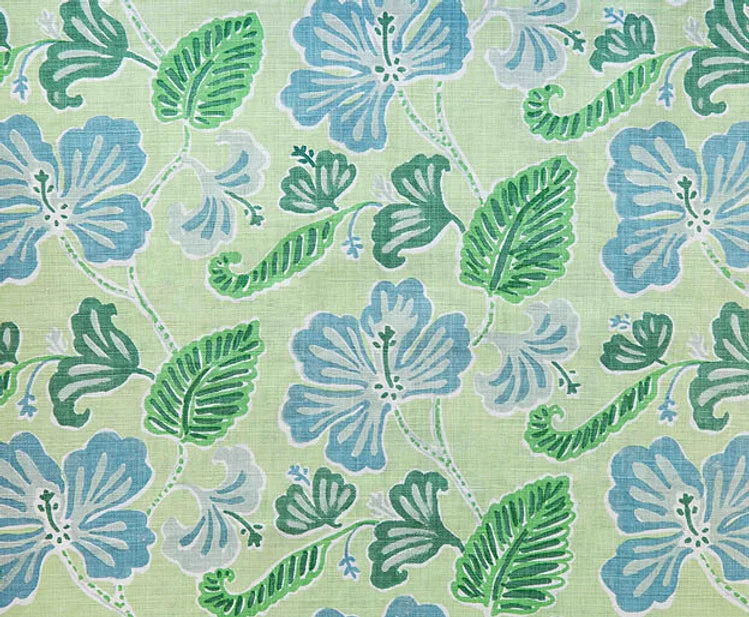 Detail of fabric in a flower and leaf print in shades of blue and green on a light green field.