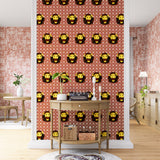 A maximalist living space with an accent wall papered in a repeating lion face pattern in red, yellow and brown.