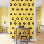 A maximalist living space with an accent wall papered in a repeating lion face pattern in tan, brown and yellow.