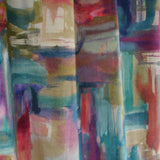 Draped fabric yardage in an abstract painterly print in shades of pink, turquoise and yellow.