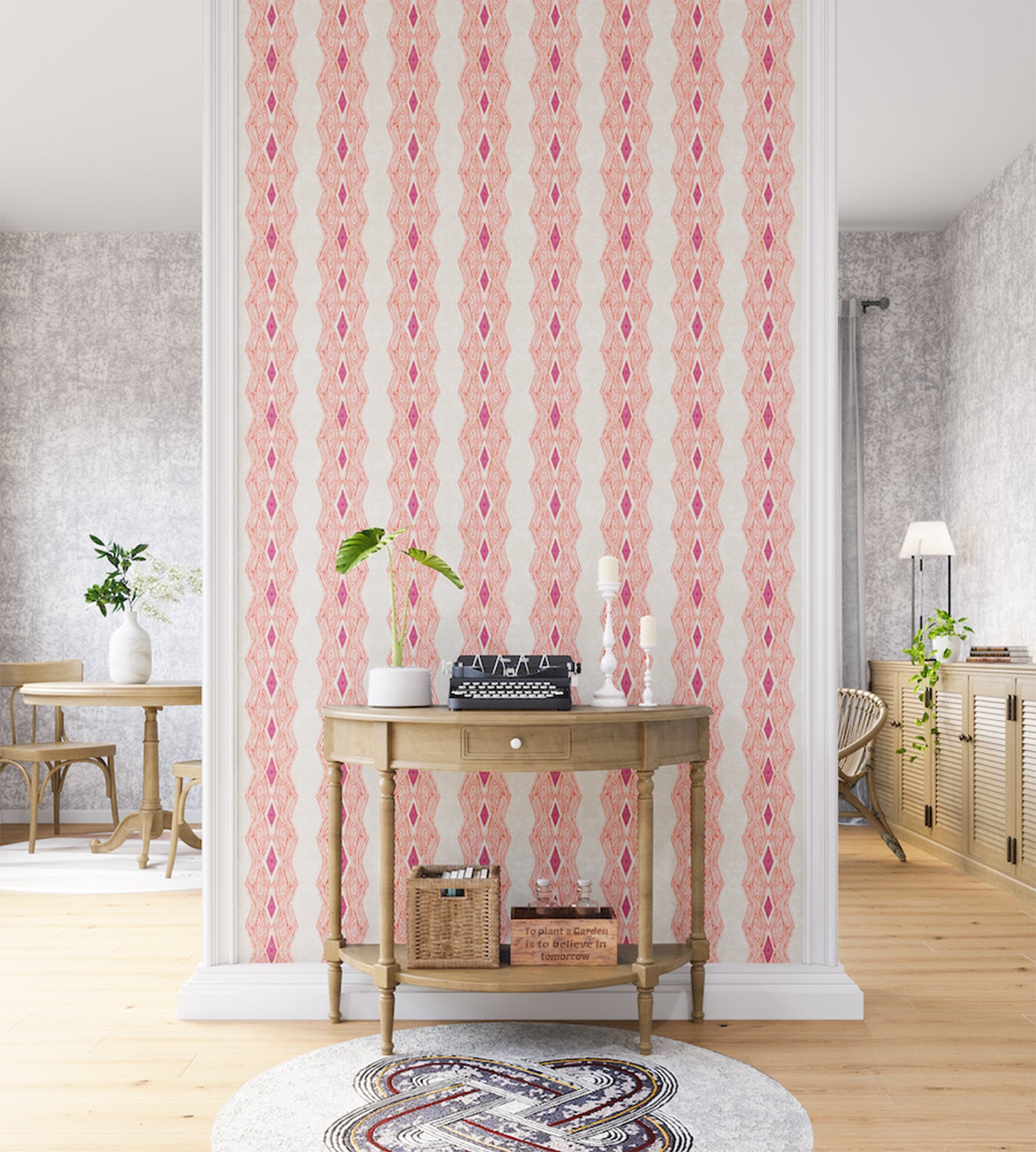 A maximalist living space with an accent wall papered in an intricate diamond stripe print in pink, orange and cream.