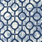 Detail of fabric in a rounded lattice print in navy on a mottled blue field.