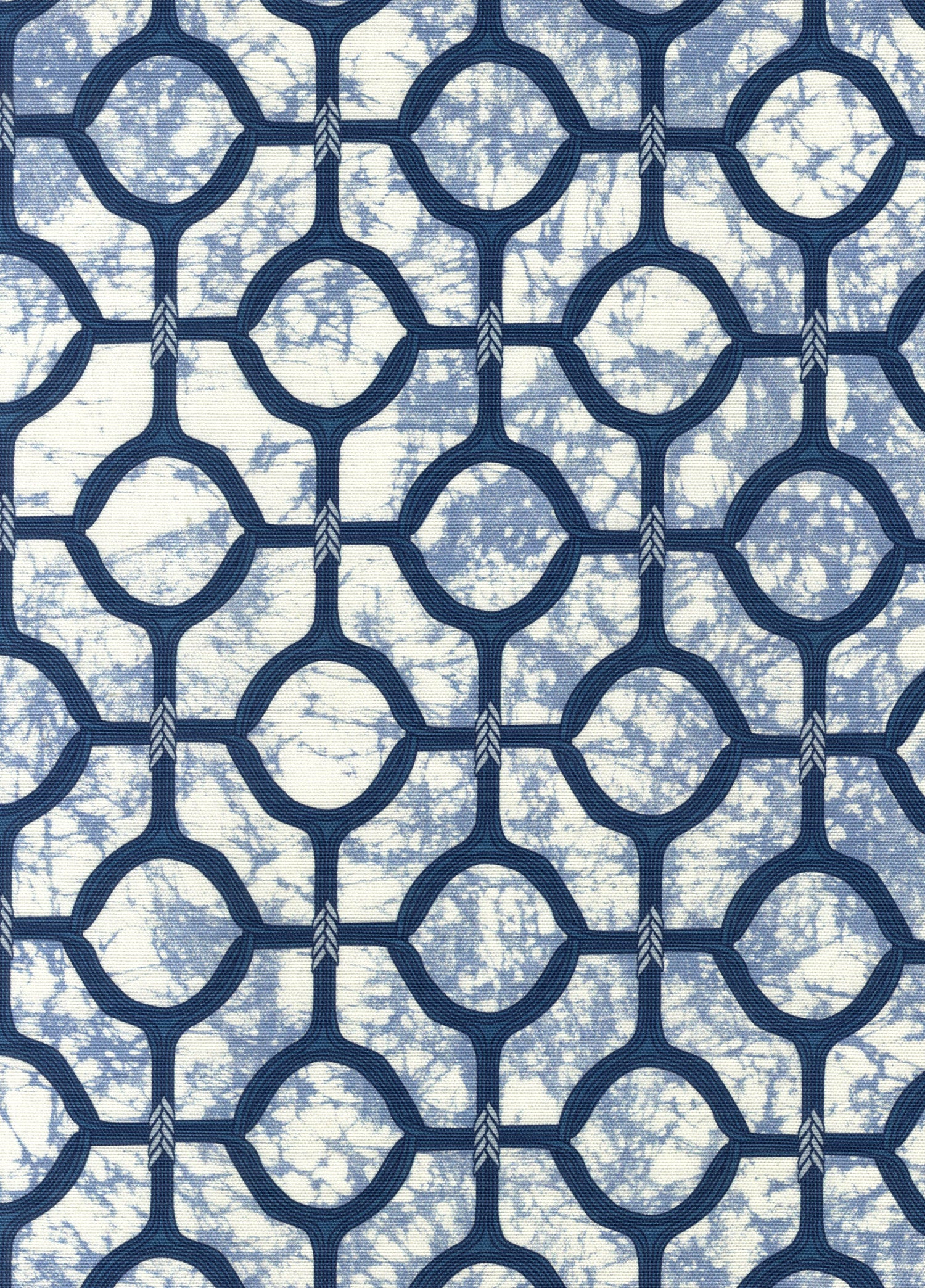 Detail of fabric in a rounded lattice print in navy on a mottled blue field.