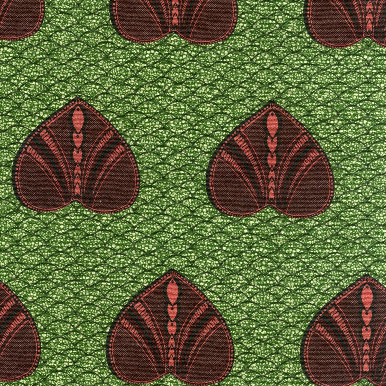 Detail of fabric in a geometric heart print in maroon and black on a green field.
