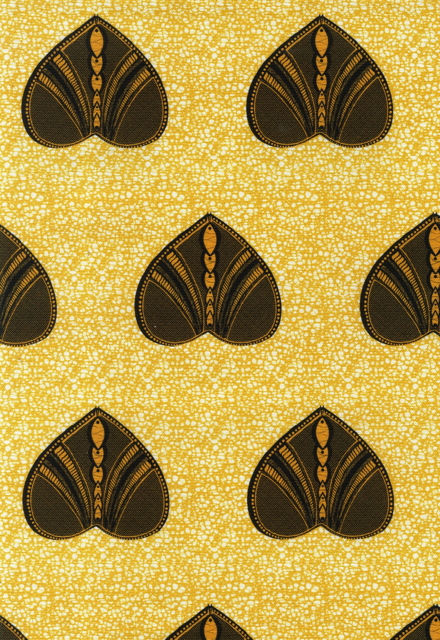 Detail of fabric in a geometric heart print in yellow and black on a yellow field.