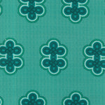 Detail of fabric in a repeating curvilinear knot print in blue and turquoise on a turquoise field.