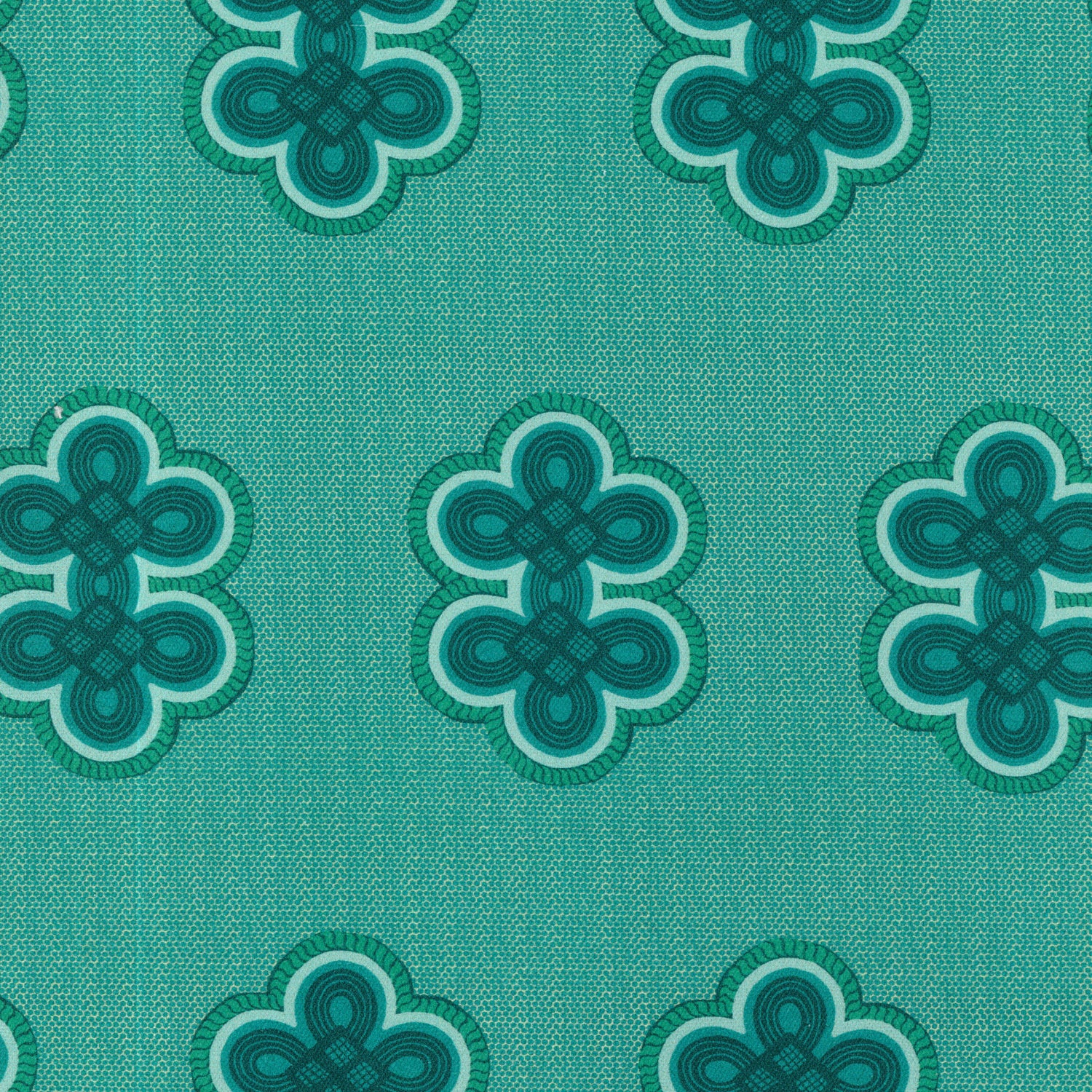 Detail of fabric in a repeating curvilinear knot print in blue and turquoise on a turquoise field.