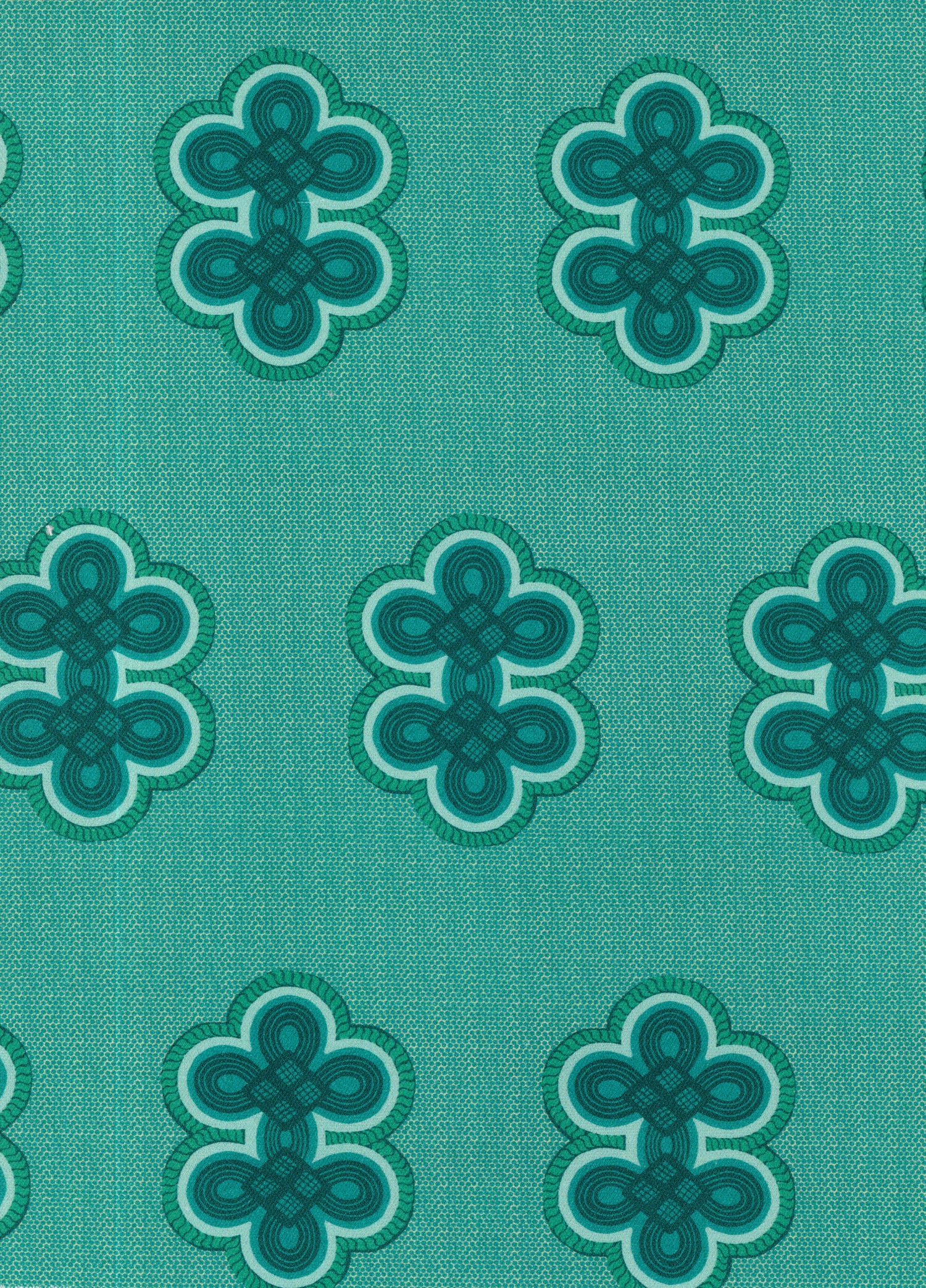 Detail of fabric in a repeating curvilinear knot print in blue and turquoise on a turquoise field.