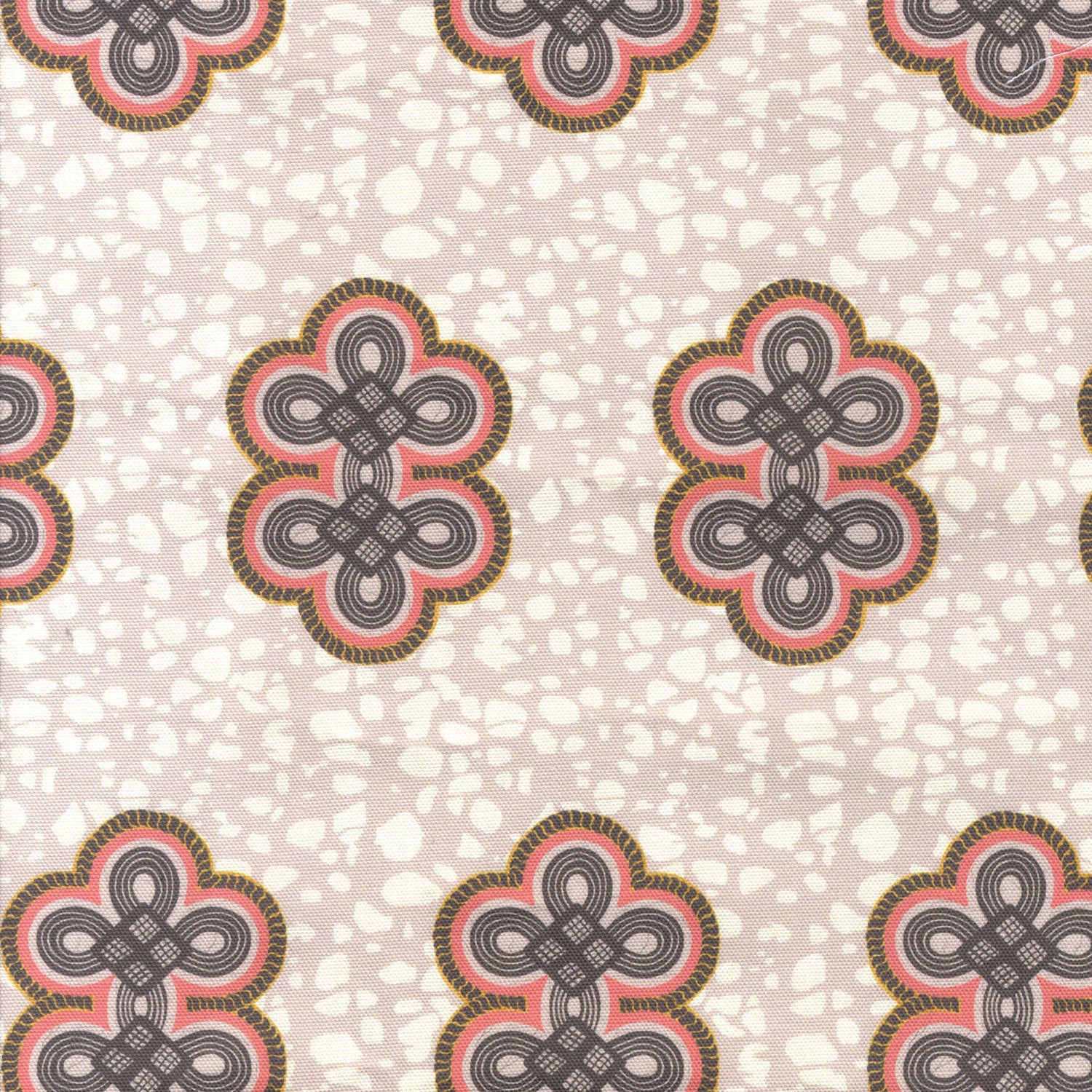 Detail of fabric in a repeating curvilinear knot print in coral and gray on a cream field.