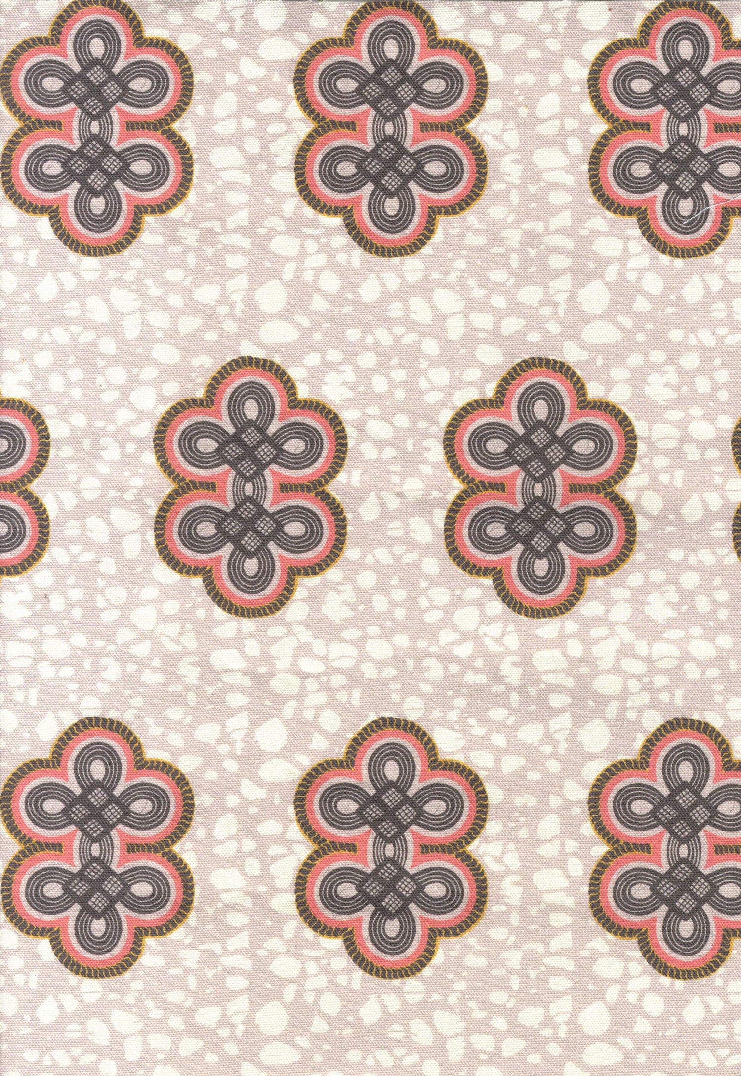 Detail of fabric in a repeating curvilinear knot print in coral and gray on a cream field.