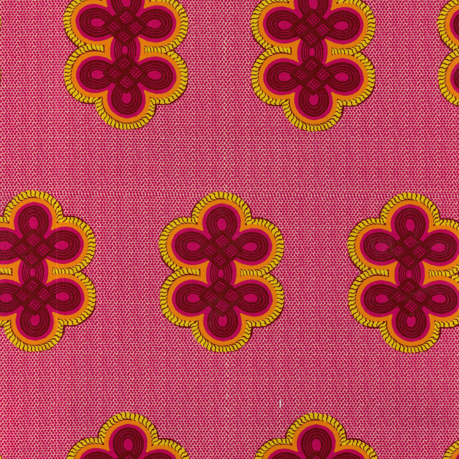 Detail of fabric in a repeating curvilinear knot print in pink and orange on a pink field.