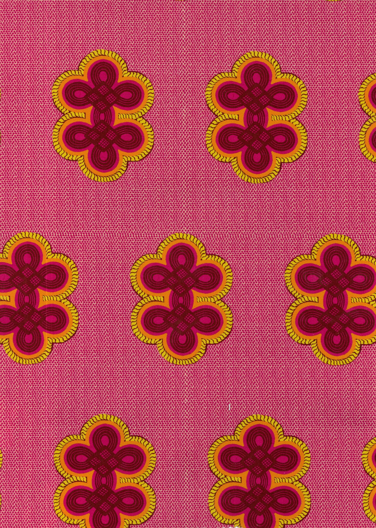 Detail of fabric in a repeating curvilinear knot print in pink and orange on a pink field.