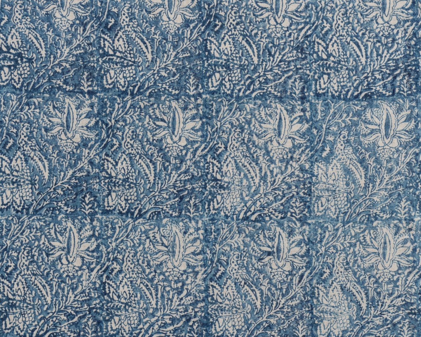Detail of fabric in a paisley block print in cream on a navy field.
