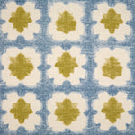 Detail of fabric in a dyed grid print in olive and blue on a cream field.