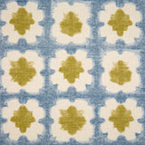 Detail of fabric in a dyed grid print in olive and blue on a cream field.