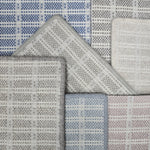 Broadloom carpet samples in a slim check pattern in a range of blue, grey and pink.