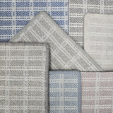 Broadloom carpet samples in a slim check pattern in a range of blue, grey and pink.