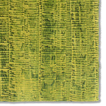 Detail of a hand-painted wallpaper swatch with an undulating ribbon pattern in green on a gold field.
