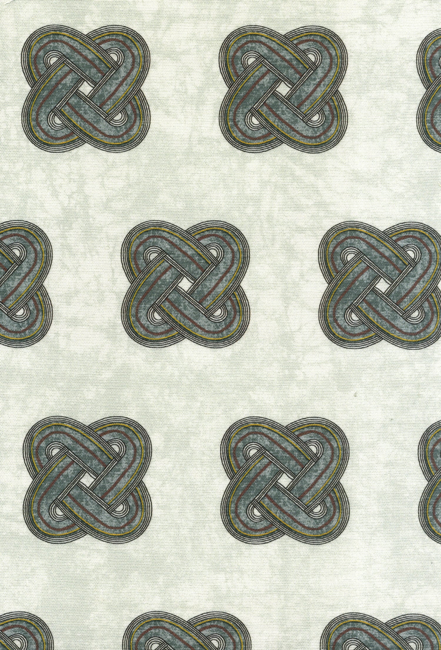 Detail of fabric in a repeating knot print in gray and yellow on a gray field.