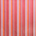 Detail of outdoor fabric in an irregular stripe print in shades of red, orange and white.