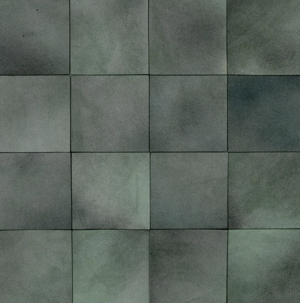 Detail of leather wall tiles in a square pattern in mottled gray and turquoise.