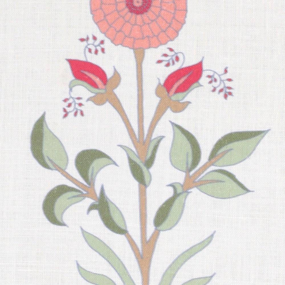 Detail of fabric in a large-scale marigold print in coral, red and green on a white field.