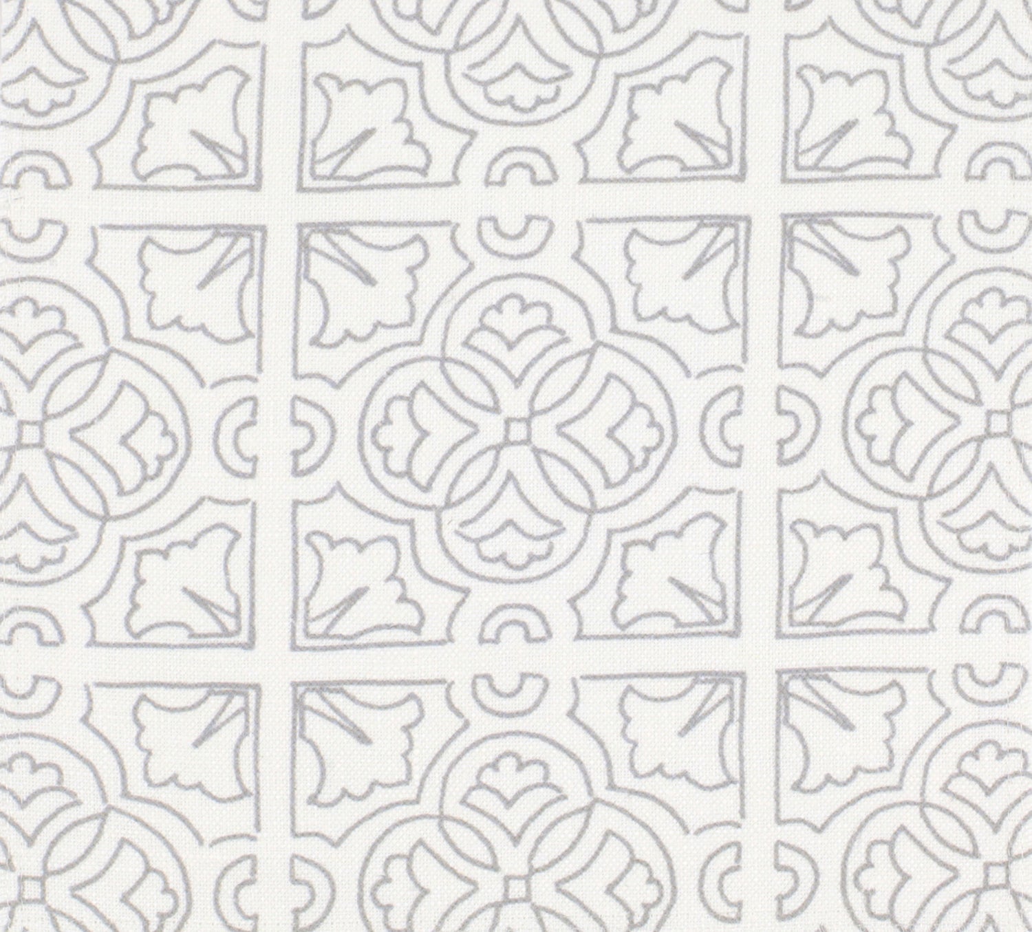 Detail of fabric in a damask lattice print in light gray on a white field.