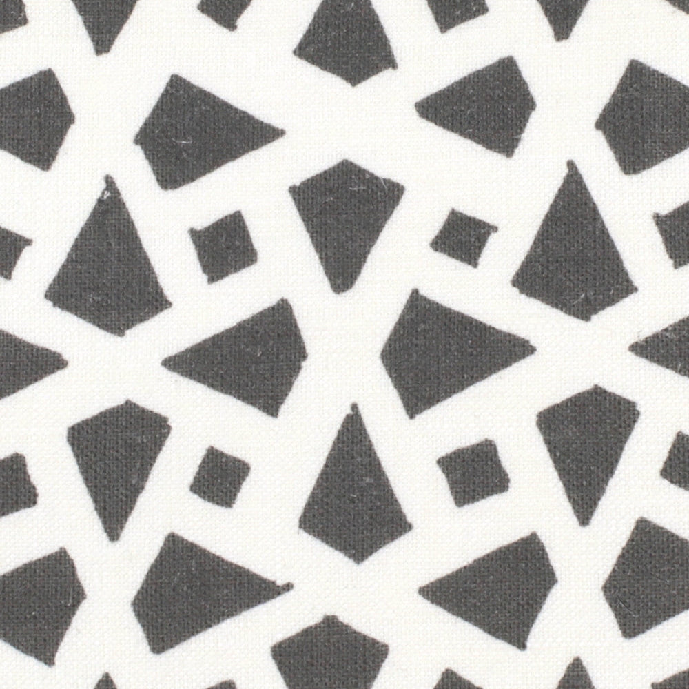 Detail of fabric in a geometric lattice print in charcoal on a white field.