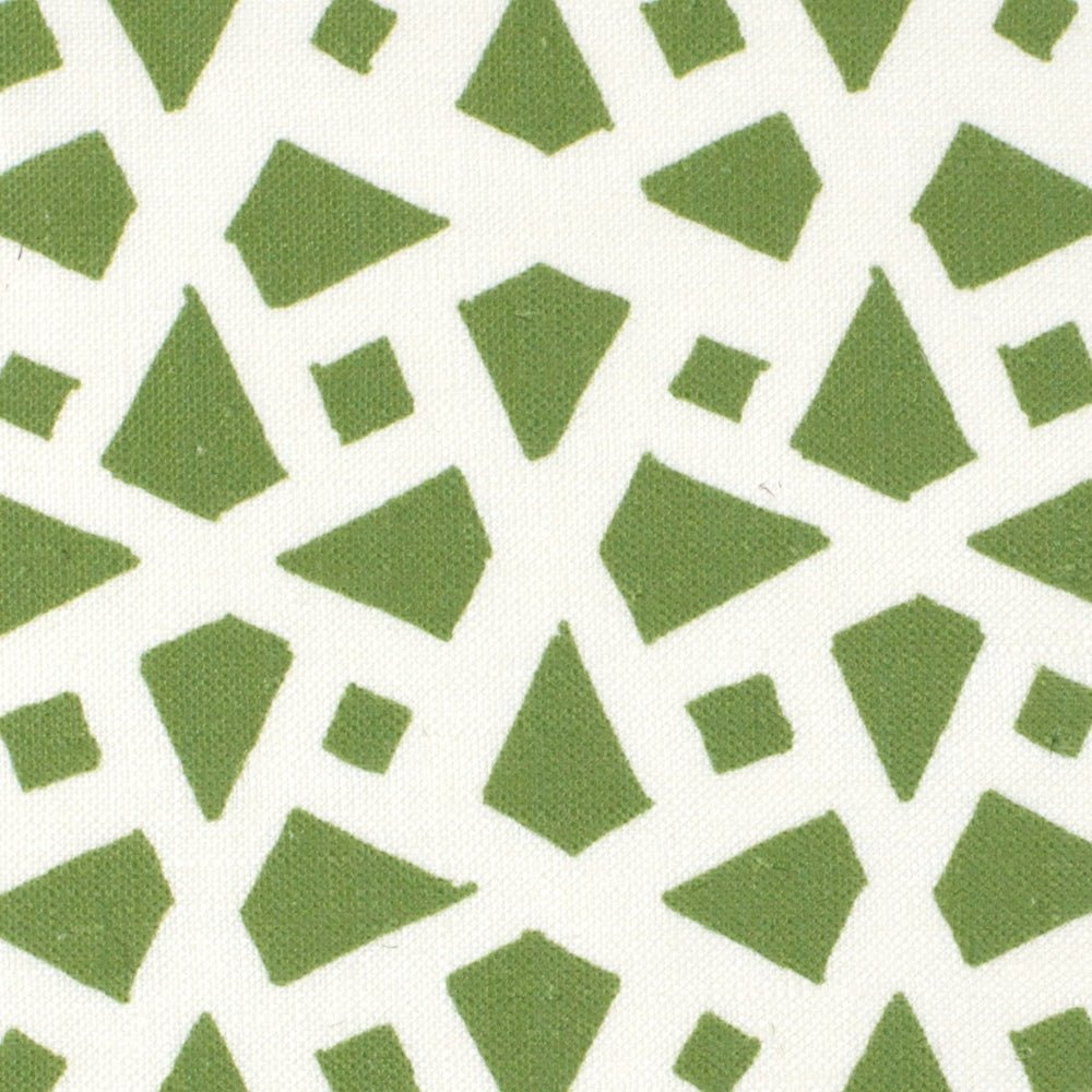 Detail of fabric in a geometric lattice print in green on a white field.