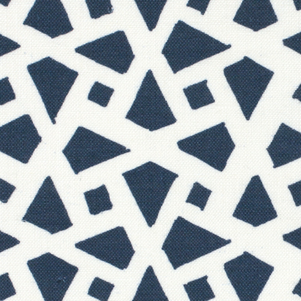 Detail of fabric in a geometric lattice print in navy on a white field.