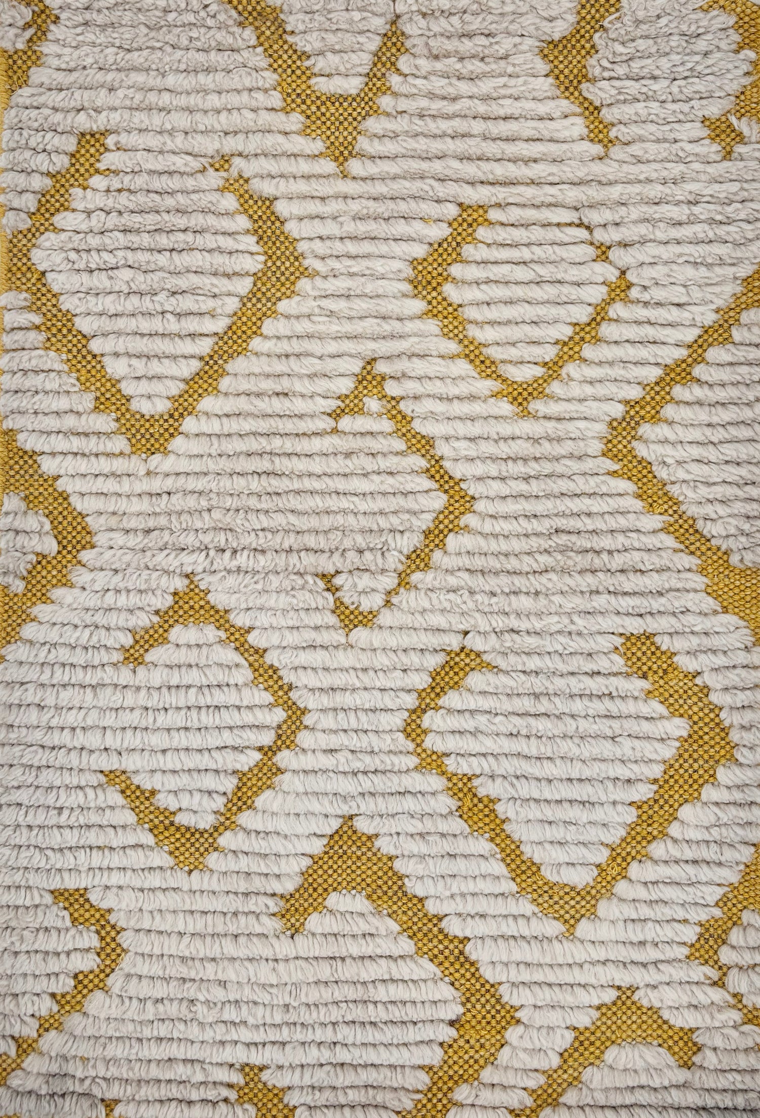 Handknotted rug sample in a Moroccan motif with ivory cut pile and yellow ground.