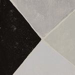 Detail of wallpaper in an abstract geometric print in shades of gray, blue and green on a cream field.