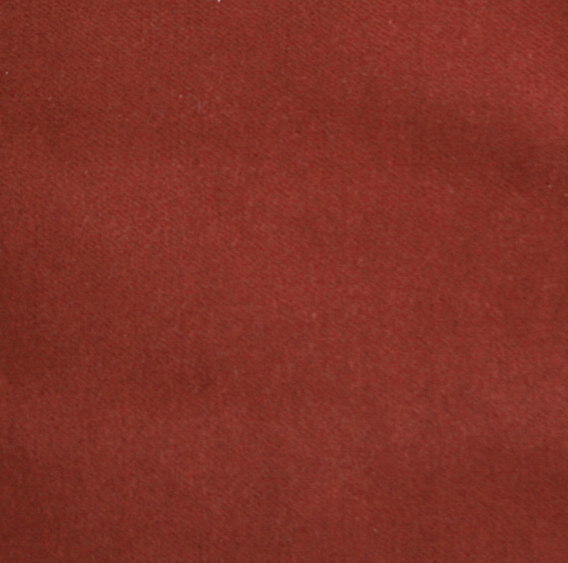 Detail of velvet fabric yardage in rust.