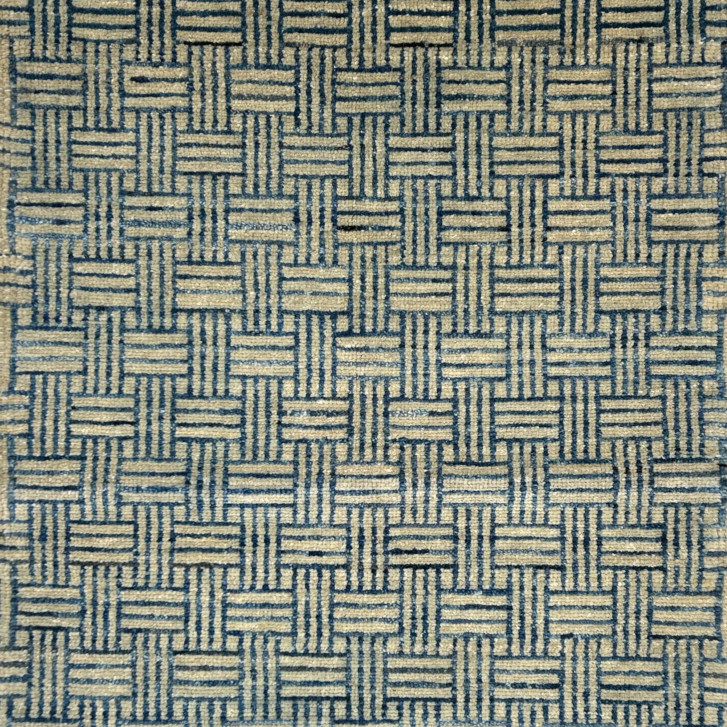 Handknotted rug in a basketweave design in blue and grey. 